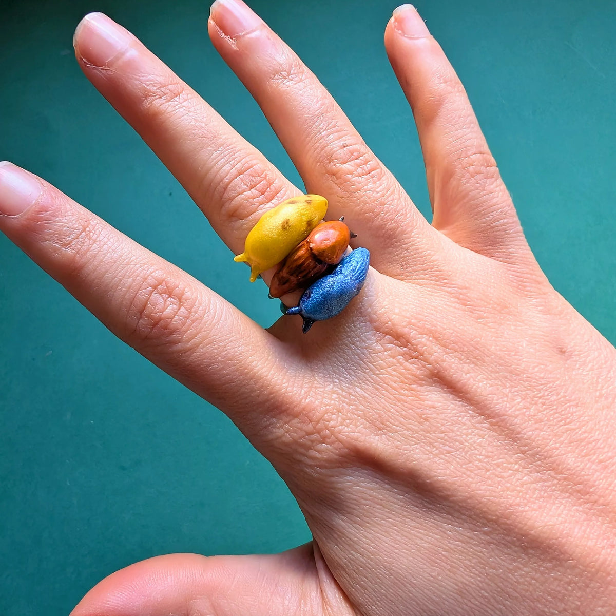 Bague réglable support acier inoxydable limace orange bleue banane